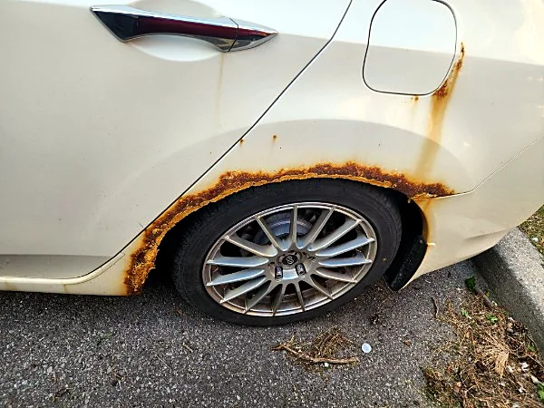 Mechanic Nation real work: Before: rust bubbling around the rear wheel arch